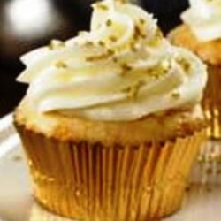 New Year's Champaign Cupcake with White Chocolate Butter Cream Frosting in gold foil with gold sprinkles.
