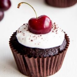 Black Forest Cherry Cupcake. Chocolate cupcake with Cherry Filling. Topped with Stiffened Whipped Cream Frosting ad a fresh Cherry.