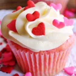 Happy Valentine's Day. Pink Velvet Cupcake, Cream Cheese Frosting and Candy Heart Sprinkles.
